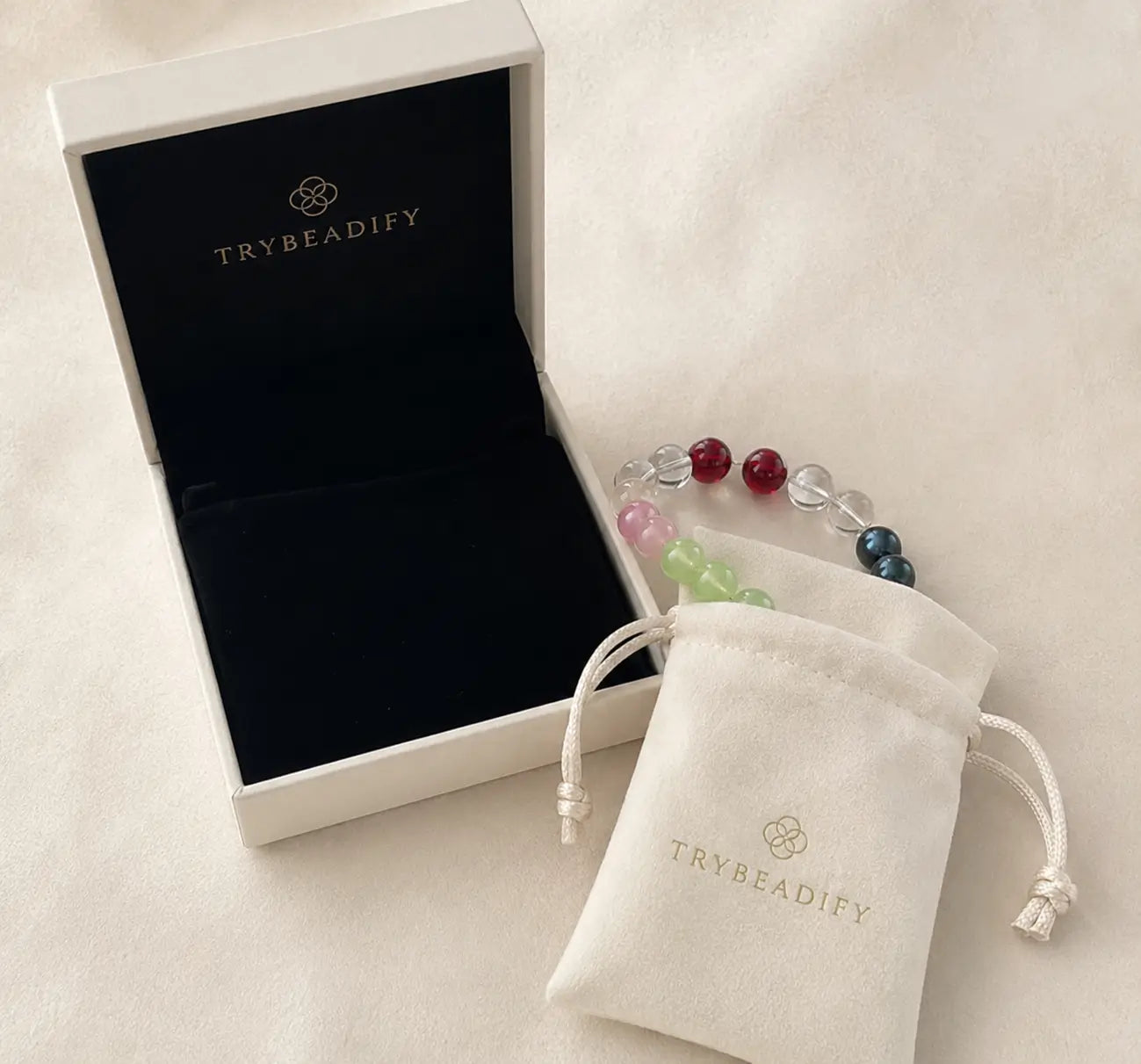 Premium gift packaging with a custom crystal bracelet displayed beside a jewelry box and soft storage pouch.